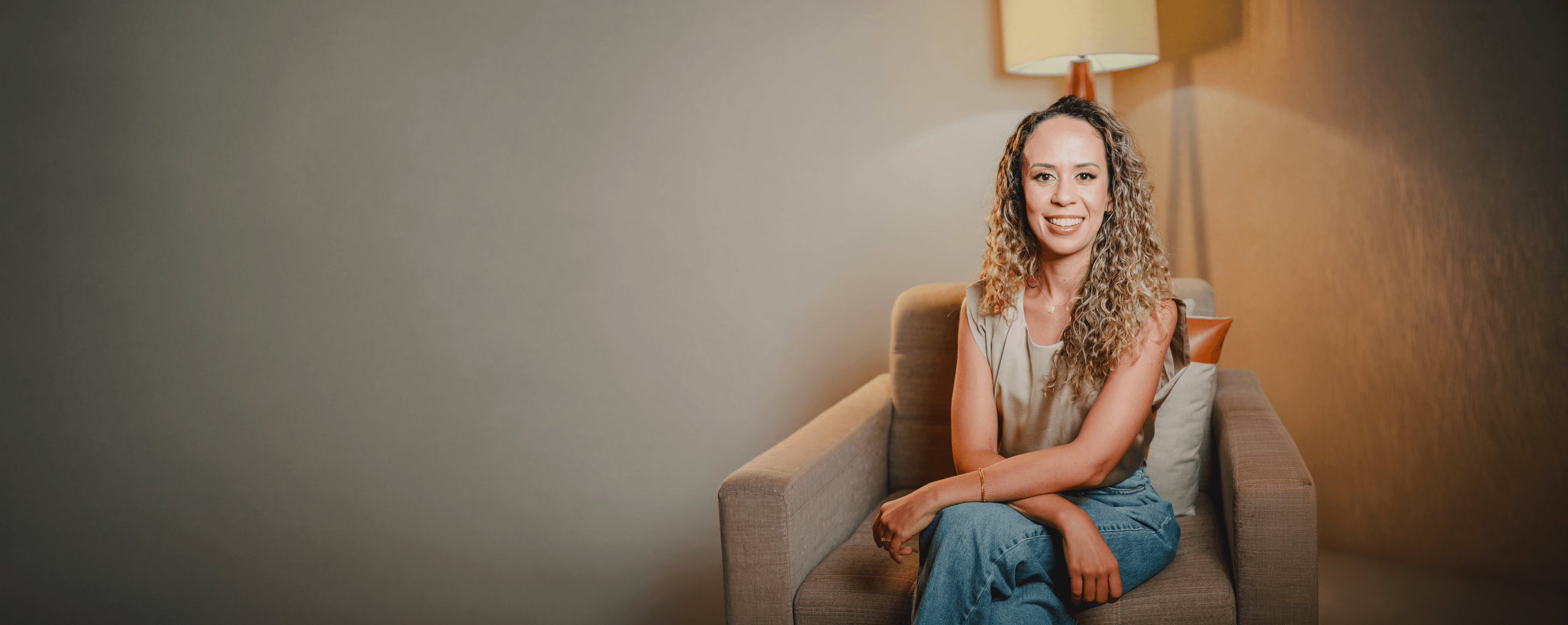 Camila Rosa, psicóloga, sentada em sessão, com expressão calma e acolhedora